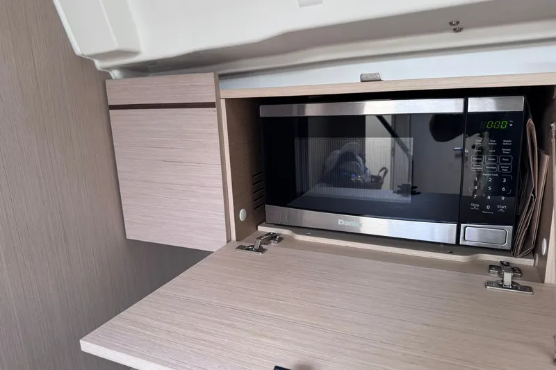 Slide: The Image of Microwave in Beneteau Oceanis 46.1 yacht's modern wooden cabinet, 2022 model. - 47