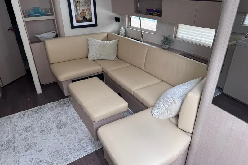 Slide: The Image of Luxurious interior of 2022 Beneteau Oceanis 46.1 yacht with beige seating and modern decor. - 21