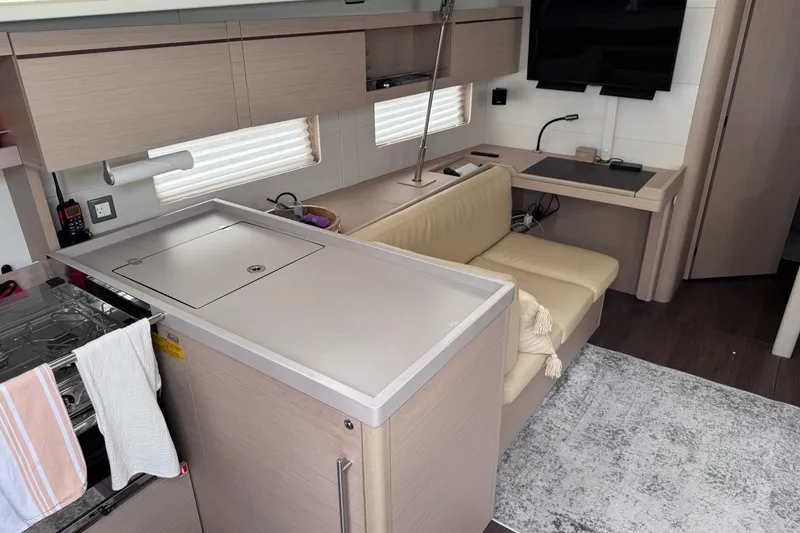 Slide: The Image of Interior of 2022 Beneteau Oceanis 46.1 yacht featuring modern kitchen and seating area. - 22