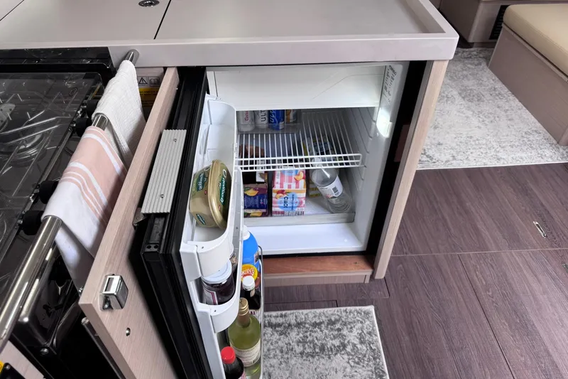 Slide: The Image of Compact kitchen fridge in 2022 Beneteau Oceanis 46.1 yacht interior. - 51