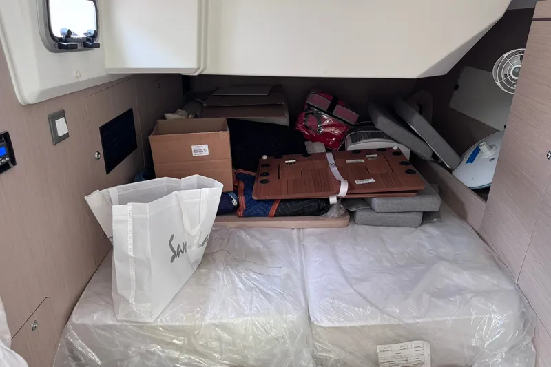 Slide: The Image of Interior cabin of 2022 Beneteau Oceanis 46.1 yacht with stored items and packaging. - 43