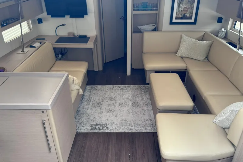 Slide: The Image of Luxurious interior of 2022 Beneteau Oceanis 46.1 yacht with beige seating and modern decor. - 35