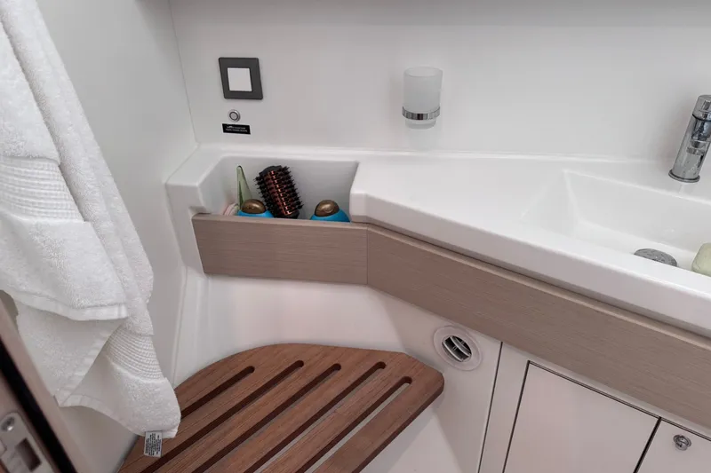 Slide: The Image of Bathroom interior of 2022 Beneteau Oceanis 46.1 yacht with sink and wooden seat. - 30