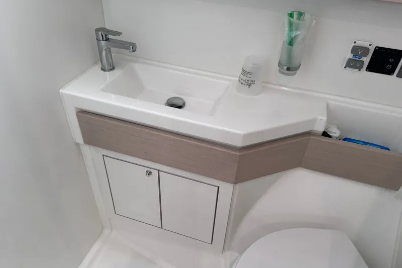 Slide: The Image of Modern bathroom sink in 2022 Beneteau Oceanis 46.1 yacht, featuring sleek design and fixtures. - 28