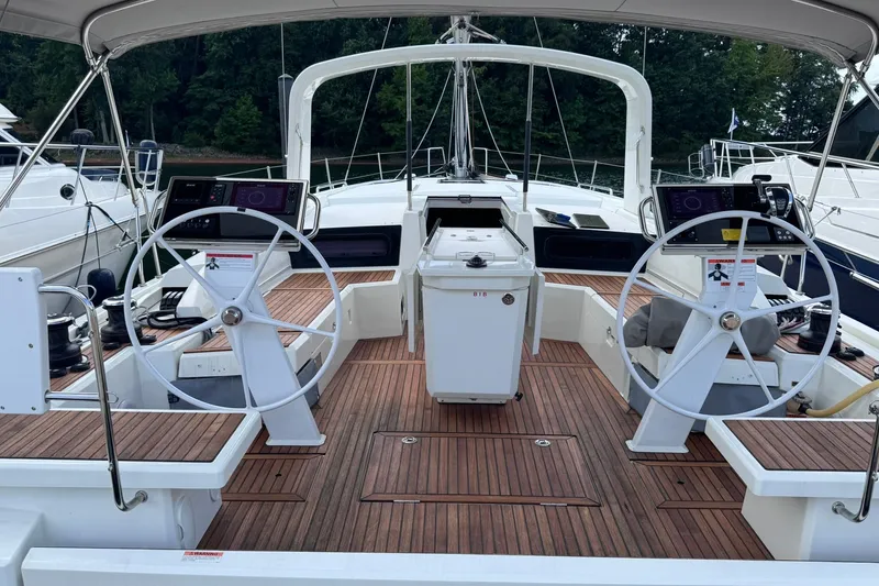Slide: The Image of Cockpit of 2022 Beneteau Oceanis 46.1 sailboat with dual steering wheels and teak decking. - 16
