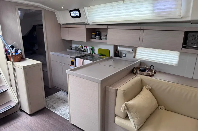 Slide: The Image of Modern interior of 2022 Beneteau Oceanis 46.1 yacht, featuring a sleek kitchen and cozy seating area. - 44