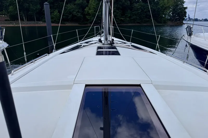 Slide: The Image of 2022 Beneteau Oceanis 46.1 yacht deck with sleek design and scenic water backdrop. - 14