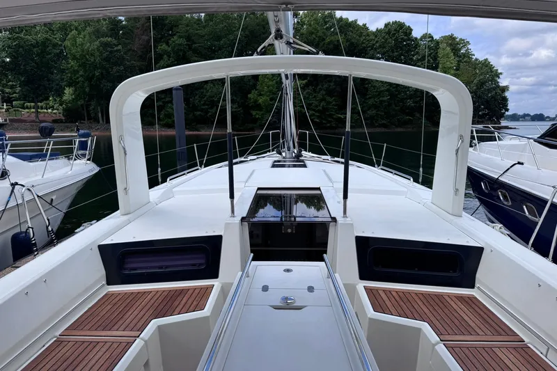 Slide: The Image of Beneteau Oceanis 46.1 yacht deck, 2022 model, docked with lush greenery in the background. - 11
