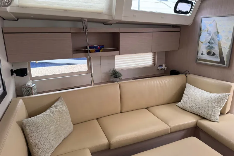 Slide: The Image of Interior of 2022 Beneteau Oceanis 46.1 yacht with beige seating and modern decor. - 41