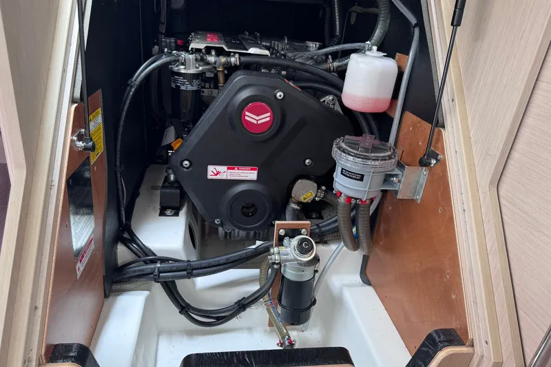 Slide: The Image of Engine compartment of a 2022 Beneteau Oceanis 46.1 sailboat, showcasing mechanical components. - 52