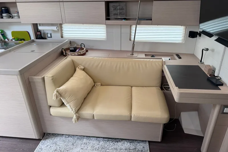 Slide: The Image of Interior of 2022 Beneteau Oceanis 46.1 yacht with beige seating and modern design. - 42