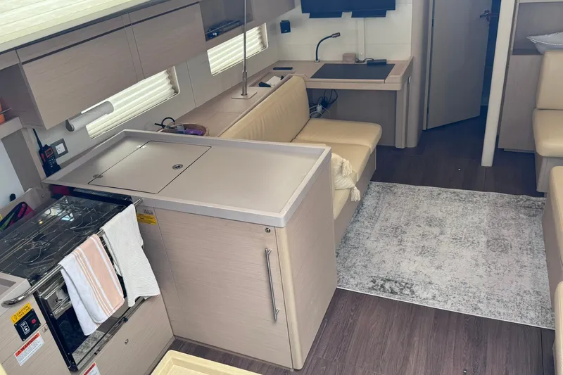 Slide: The Image of Modern interior of 2022 Beneteau Oceanis 46.1 yacht with kitchen and seating area. - 36