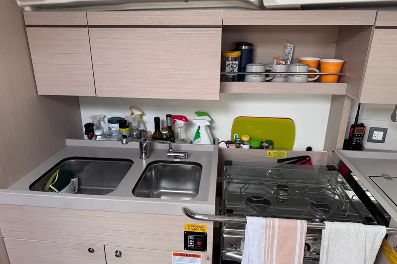 Slide: The Image of Modern kitchen in 2022 Beneteau Oceanis 46.1 yacht with dual sinks and stove. - 49