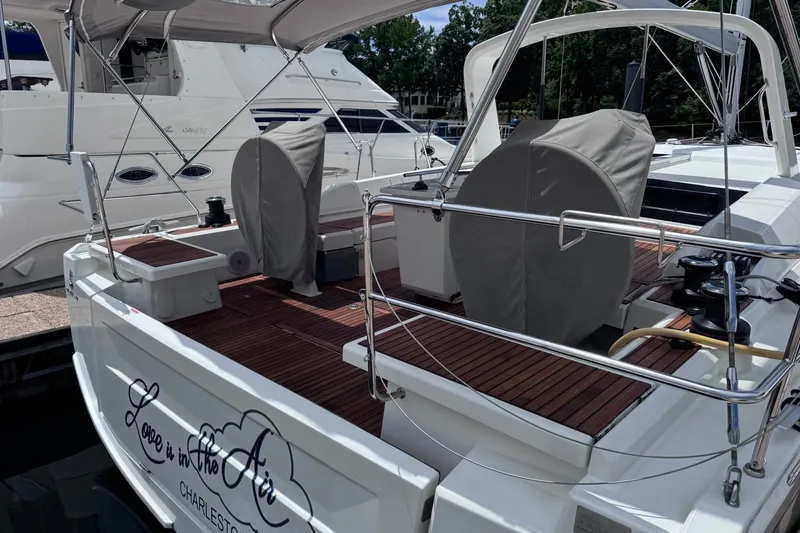 Slide: The Image of 2022 Beneteau Oceanis 46.1 yacht docked, featuring elegant deck design and covered helm. - 4
