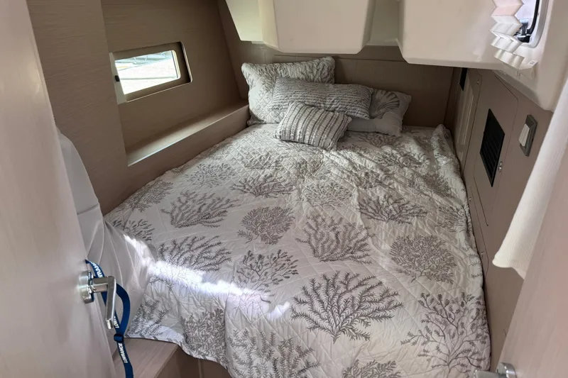 Slide: The Image of Cozy cabin interior of 2022 Beneteau Oceanis 46.1 with patterned bedding. - 31