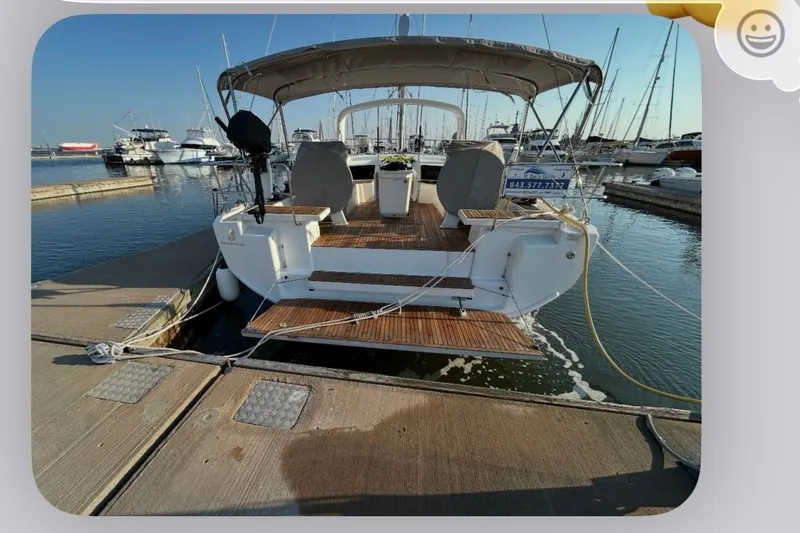 Slide: The Image of Beneteau Oceanis 46.1 yacht, 2022 model, docked at a marina with clear skies. - 3