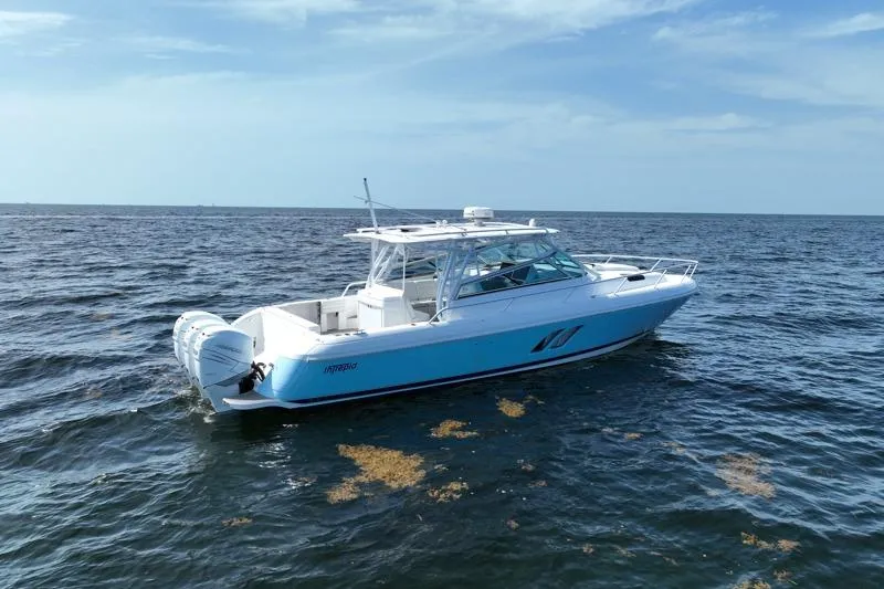 Slide: The Image of 2017 Intrepid 430 Sport Yacht cruising on open water under a clear sky. - 2