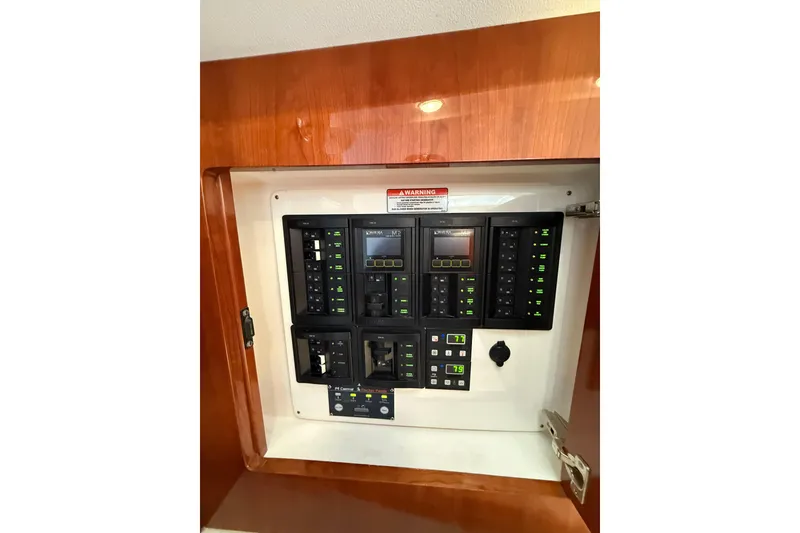 Slide: The Image of Electrical panel inside 2017 Intrepid 430 Sport Yacht, featuring various switches and controls. - 20
