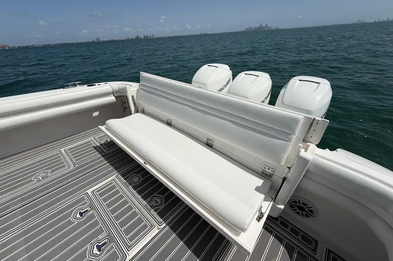 Slide: The Image of 2017 Intrepid 430 Sport Yacht with foldable seating and triple outboard engines on open water. - 51