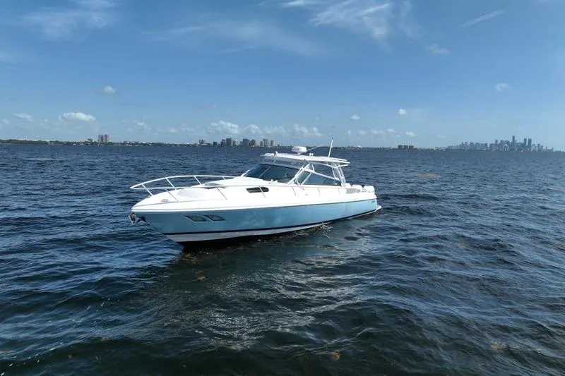 Slide: The Image of 2017 Intrepid 430 Sport Yacht cruising on open water under clear skies. - 6