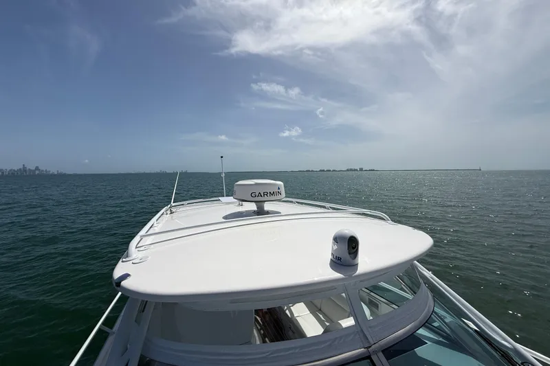 Slide: The Image of 2017 Intrepid 430 Sport Yacht cruising on open water under a clear sky. - 41