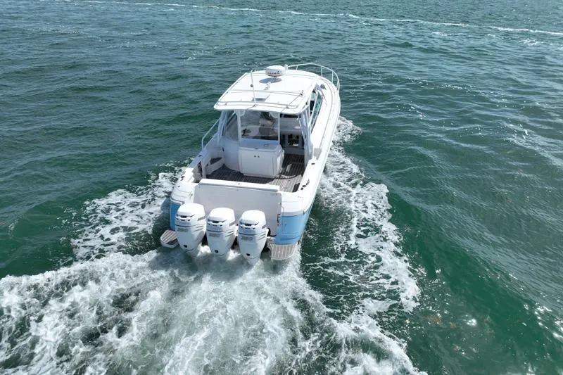 Slide: The Image of 2017 Intrepid 430 Sport Yacht cruising on open water, rear view. - 16