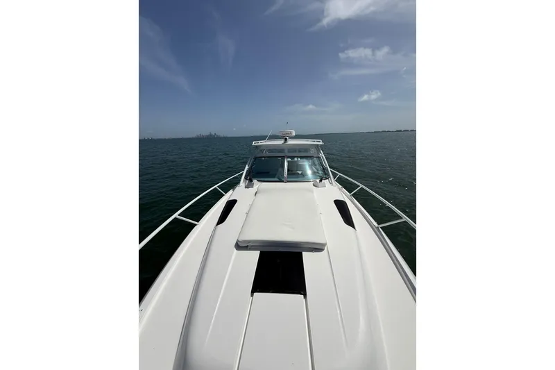 Slide: The Image of 2017 Intrepid 430 Sport Yacht cruising on open water under clear skies. - 58