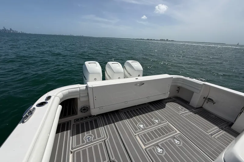Slide: The Image of 2017 Intrepid 430 Sport Yacht on open water, featuring triple outboard engines. - 49