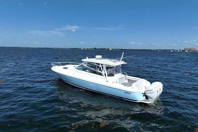 Slide: The Image of 2017 Intrepid 430 Sport Yacht cruising on open water under clear blue skies. - 1