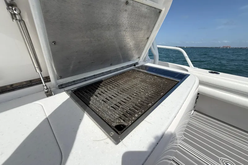 Slide: The Image of Outdoor grill on 2017 Intrepid 430 Sport Yacht, open lid, ocean view in background. - 53