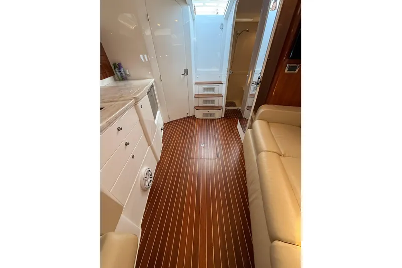 Slide: The Image of Interior of 2017 Intrepid 430 Sport Yacht with wood flooring and modern furnishings. - 27