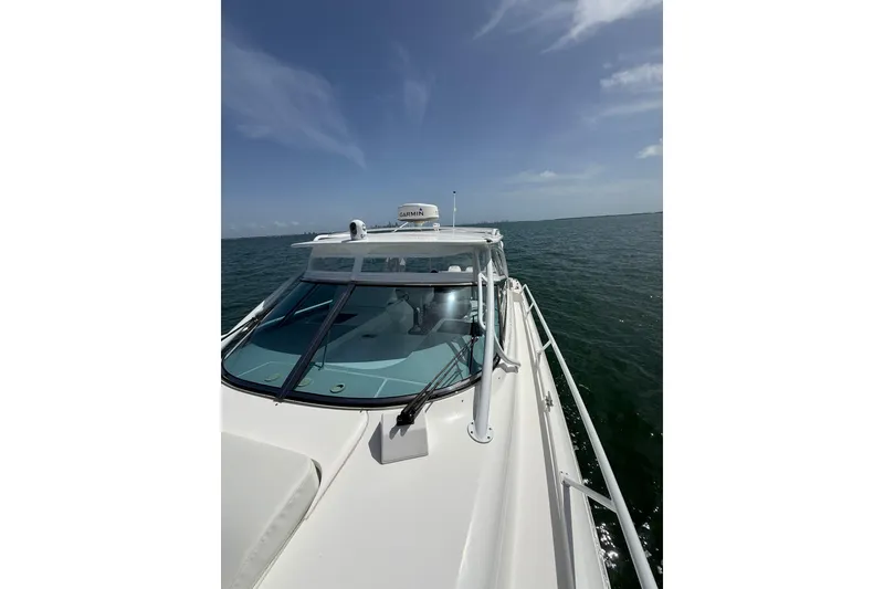 Slide: The Image of 2017 Intrepid 430 Sport Yacht cruising on open water under clear skies. - 59