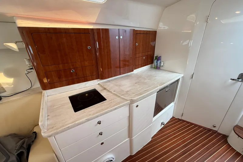 Slide: The Image of Luxurious 2017 Intrepid 430 Sport Yacht interior kitchen with sleek cabinetry and modern appliances. - 26