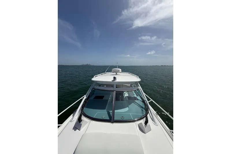 Slide: The Image of 2017 Intrepid 430 Sport Yacht cruising on open water under clear skies. - 57