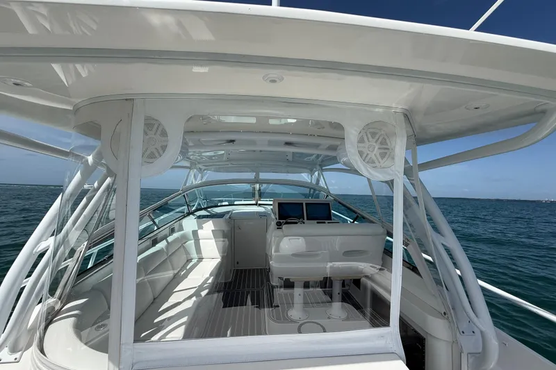 Slide: The Image of 2017 Intrepid 430 Sport Yacht interior with helm, seating, and ocean view. - 55
