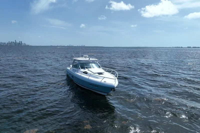 Slide: The Image of 2017 Intrepid 430 Sport Yacht cruising on open water under a clear blue sky. - 7