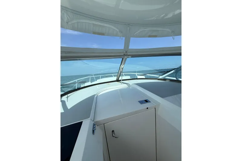 Slide: The Image of Interior view of 2017 Intrepid 430 Sport Yacht, showcasing helm and ocean horizon. - 31