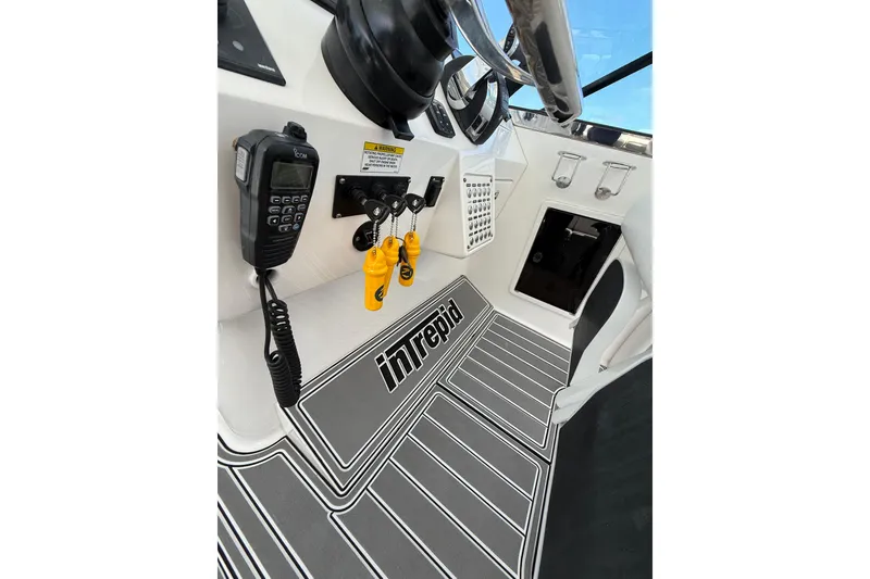 Slide: The Image of Cockpit of 2017 Intrepid 430 Sport Yacht with communication equipment and branded flooring. - 40