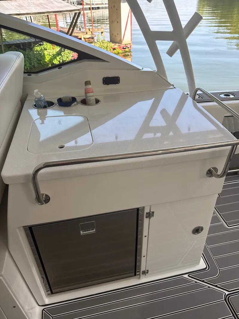 Slide: The Image of The 2024 Blackfin 272 DC features a sleek onboard kitchenette with a sink and storage. - 6