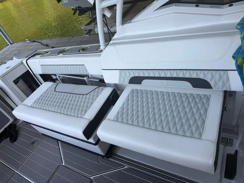 Slide: The Image of The 2024 Blackfin 272 DC features an elegant, cushioned bench with a quilted pattern. - 8