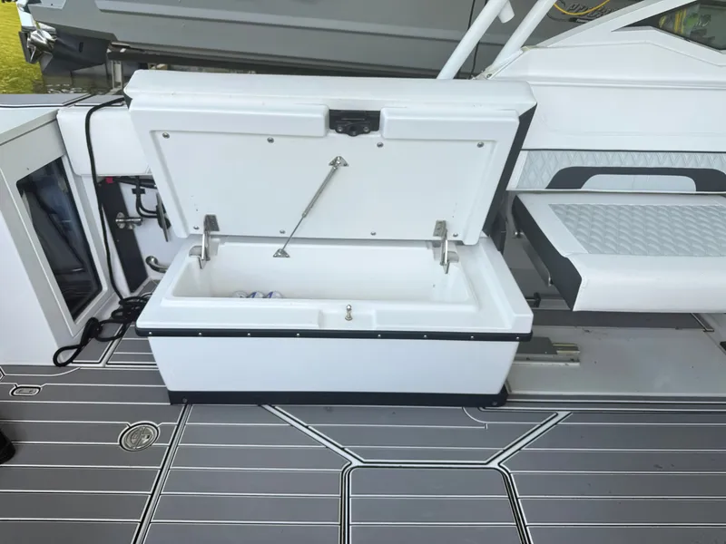 Slide: The Image of The image shows an open cooler on a boat with gray flooring. - 10