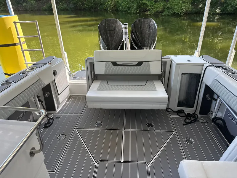 Slide: The Image of The image shows the cockpit of a 2024 Blackfin 272 DC boat with gray flooring and white seating. - 7