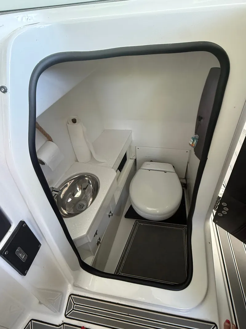 Slide: The Image of The image shows a compact boat bathroom with a sink and toilet. - 9