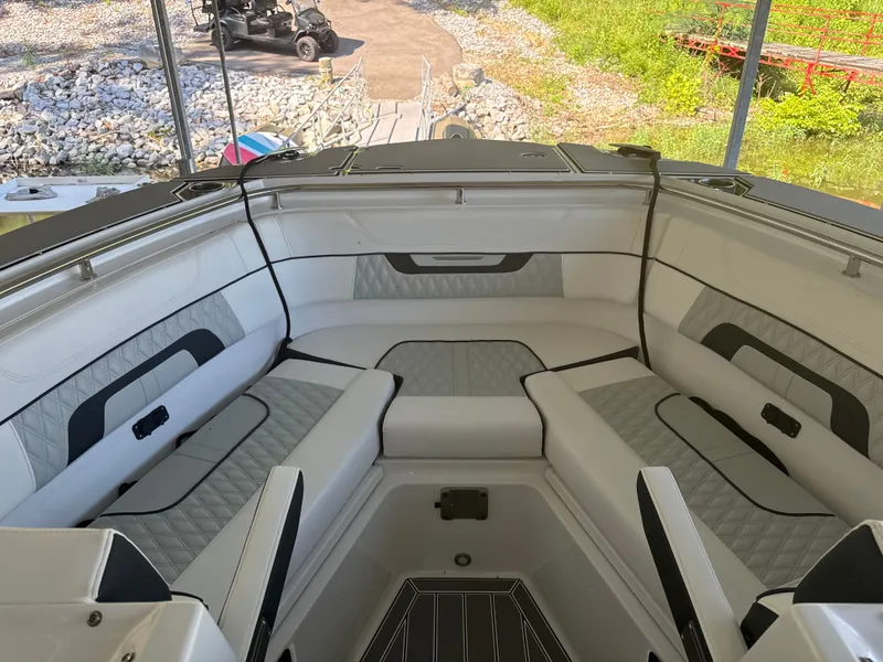 Slide: The Image of The image shows the bow area of a 2024 Blackfin 272 DC boat with cushioned seating. - 4