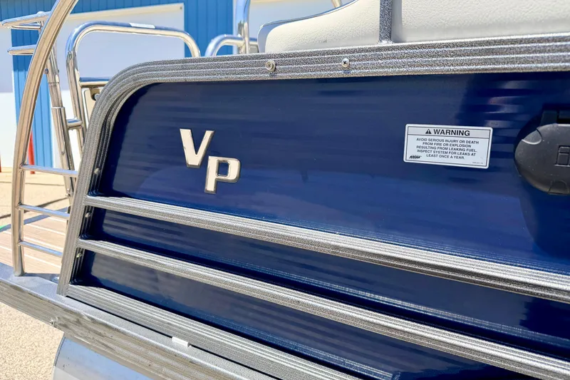 Slide: The Image of 2015 Manitou 25 SES BENCH pontoon boat with blue exterior and VP logo. - 10