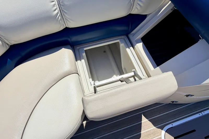Slide: The Image of 2015 Manitou 25 SES BENCH with open storage compartment on luxury seating. - 31