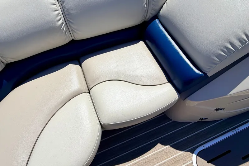 Slide: The Image of 2015 Manitou 25 SES BENCH boat seating with beige and blue upholstery. - 30