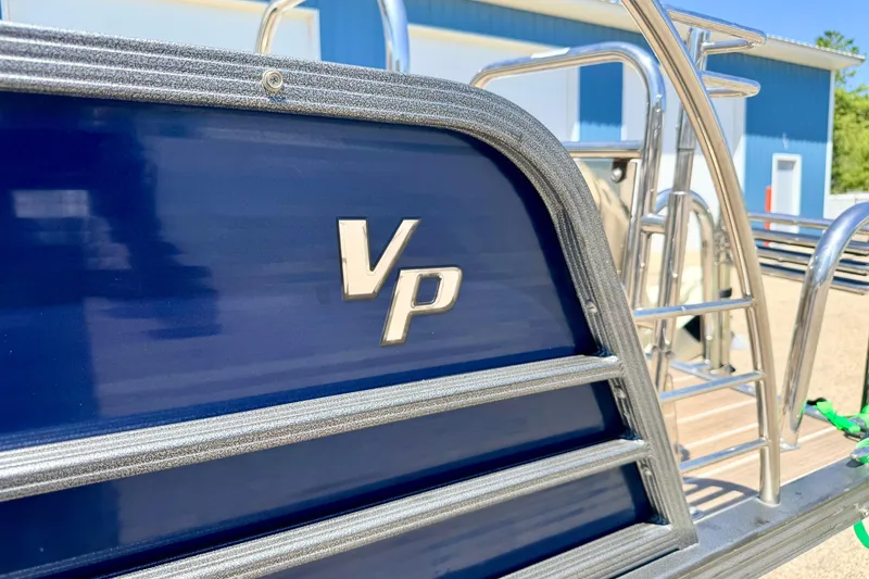 Slide: The Image of 2015 Manitou 25 SES BENCH pontoon boat with blue exterior and VP logo. - 12