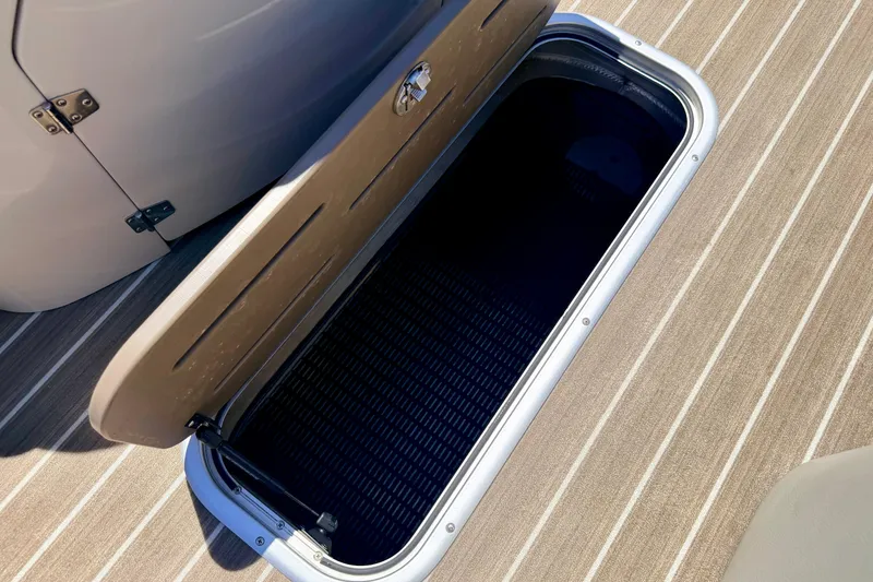 Slide: The Image of Open storage compartment on 2015 Manitou 25 SES BENCH boat deck. - 41