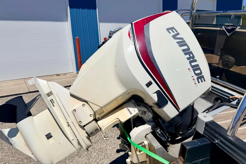 Slide: The Image of 2015 Manitou 25 SES BENCH with Evinrude E-TEC outboard motor, parked outdoors. - 18